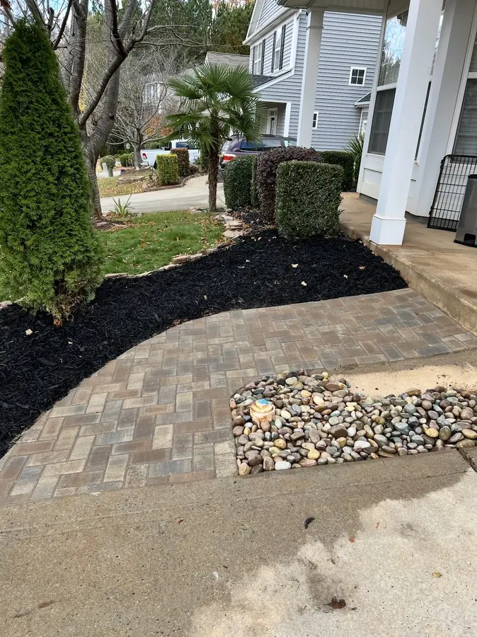 Paver walkway with river rock border
