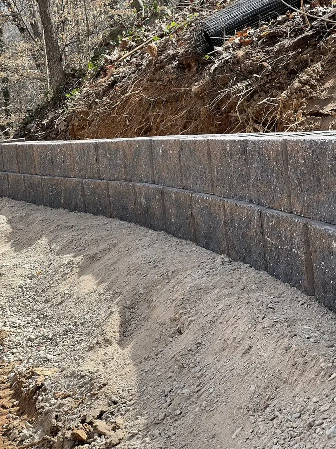 Curved retaining wall with gravel backfill